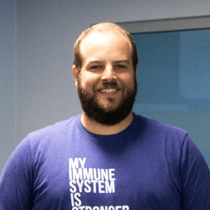 Man in blue t-shirt smiling at camera